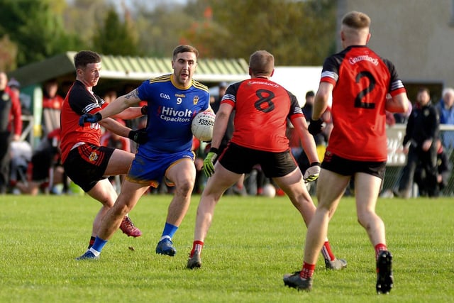 Steelstown’s Ryan Devine barges through Greenlough’s players at Ballymaguigan on Saturday afternoon last. Photo: George Sweeney. DER2144GS – 040
