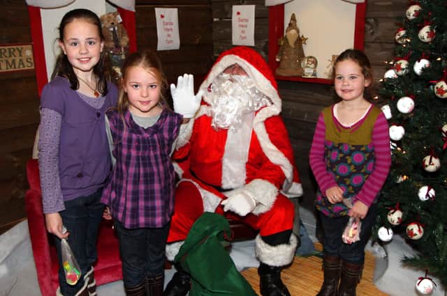 Robyn, Cara and Abbie Morton from Stewartstown pictured with Santa at CFC Interiors Cookstown Christmas launch night held in November 2009. mm46-366sr