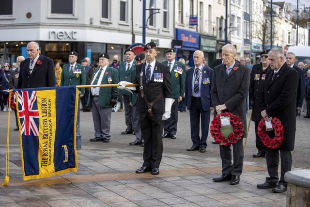 The Standard is lowered during the Armistice Day service held at the War Memorial in Coleraine on Thursday 11th November 2021.
