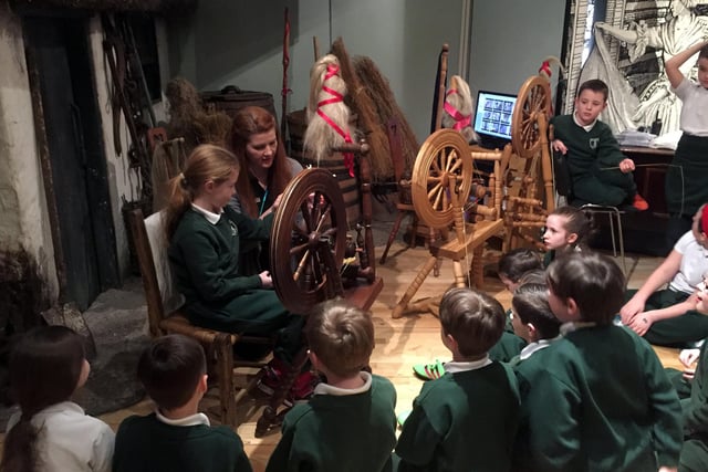 Museum staff teach pupils from St Joseph's Primary School, Carryduff, how to spin yarn. The museum works to preserve Lisburn's rich linen history.