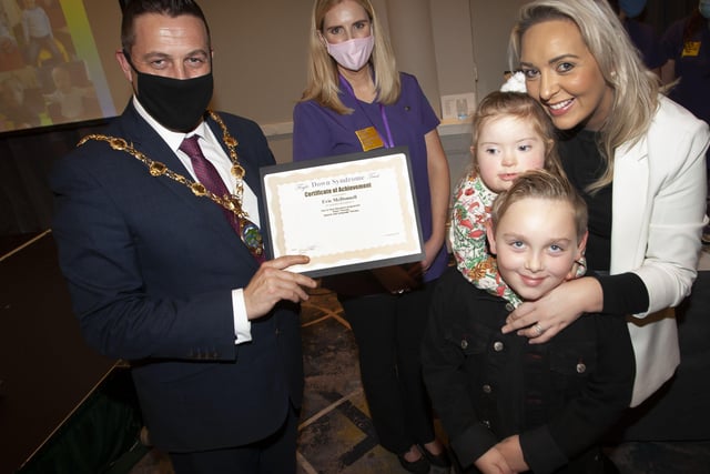 Evie McDonnell with her mum and brother recieving her certificate and present from the Mayor, Graham Warke.