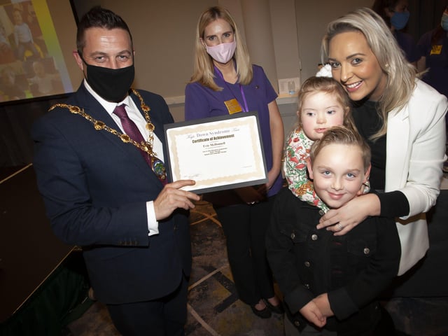 Evie McDonnell with her mum and brother recieving her certificate and present from the Mayor, Graham Warke.