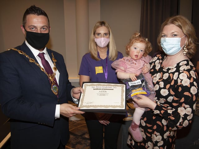Young Erin Brolly receiving her certificate and present from the Mayor Graham Warke at Thursday nigihtâ€TMs event.