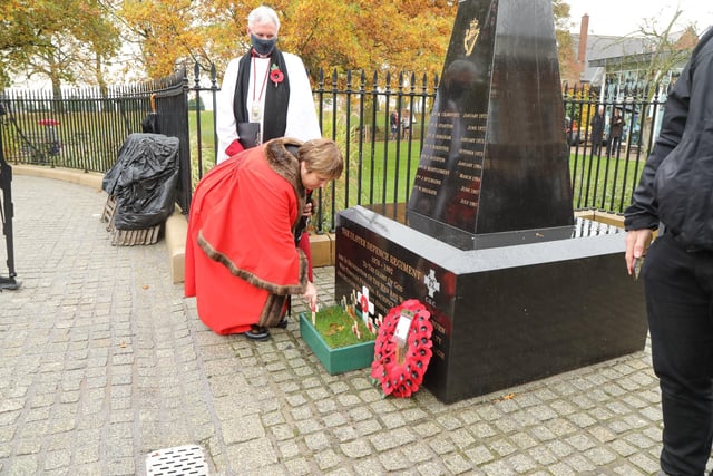 Councillor Jenny Palmer placing a cross at the UDR Memorial