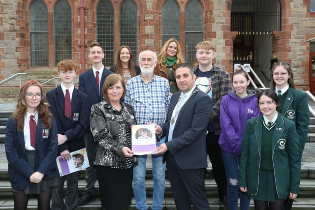Deputy Mayor Councillor Christopher Jackson and Nichola McKee Corner with students and staff from Lisneal College, St. Cecilia’s College, and Reach Across at the launch of the writing competition in memory of Lyra McKee.
