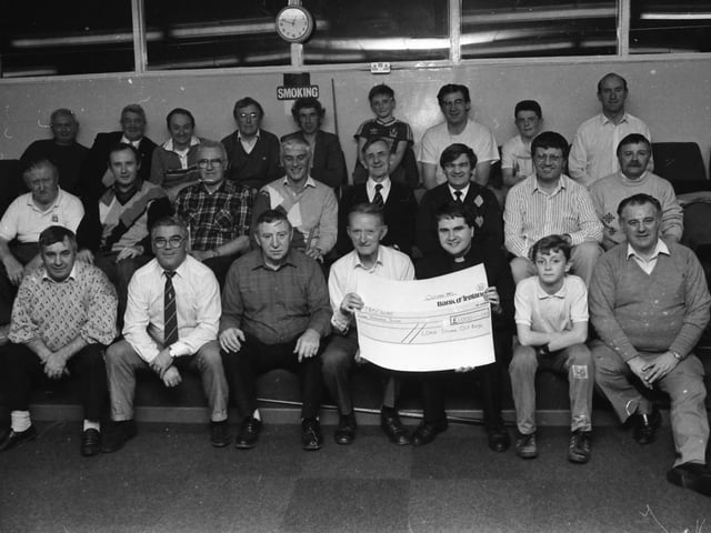 Mr. Willie Meehan, chairman of the Long Tower Old Boys’ Committee, presents a cheque of £1,000, the proceeds of a cabaret dance evening in the Delacroix lounge, to Rev. Eamon Graham, Derry Diocese representative of Trócaire. The cheque was presented at the committee’s weekly snooker session.