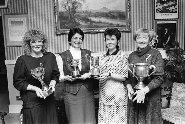 Mrs. Fidelma Doherty, captain, Redcastle Golf Club, presenting the ‘Golfer of the Year’ award to Mrs. Sylvia Huey, at an annual dinner in the Redcastle Hotel and Country Club. On right is Mrs. Elsie Owens, winner of the Redcastle Cup, and, on left, is Christine Lynch, who was runner-up.