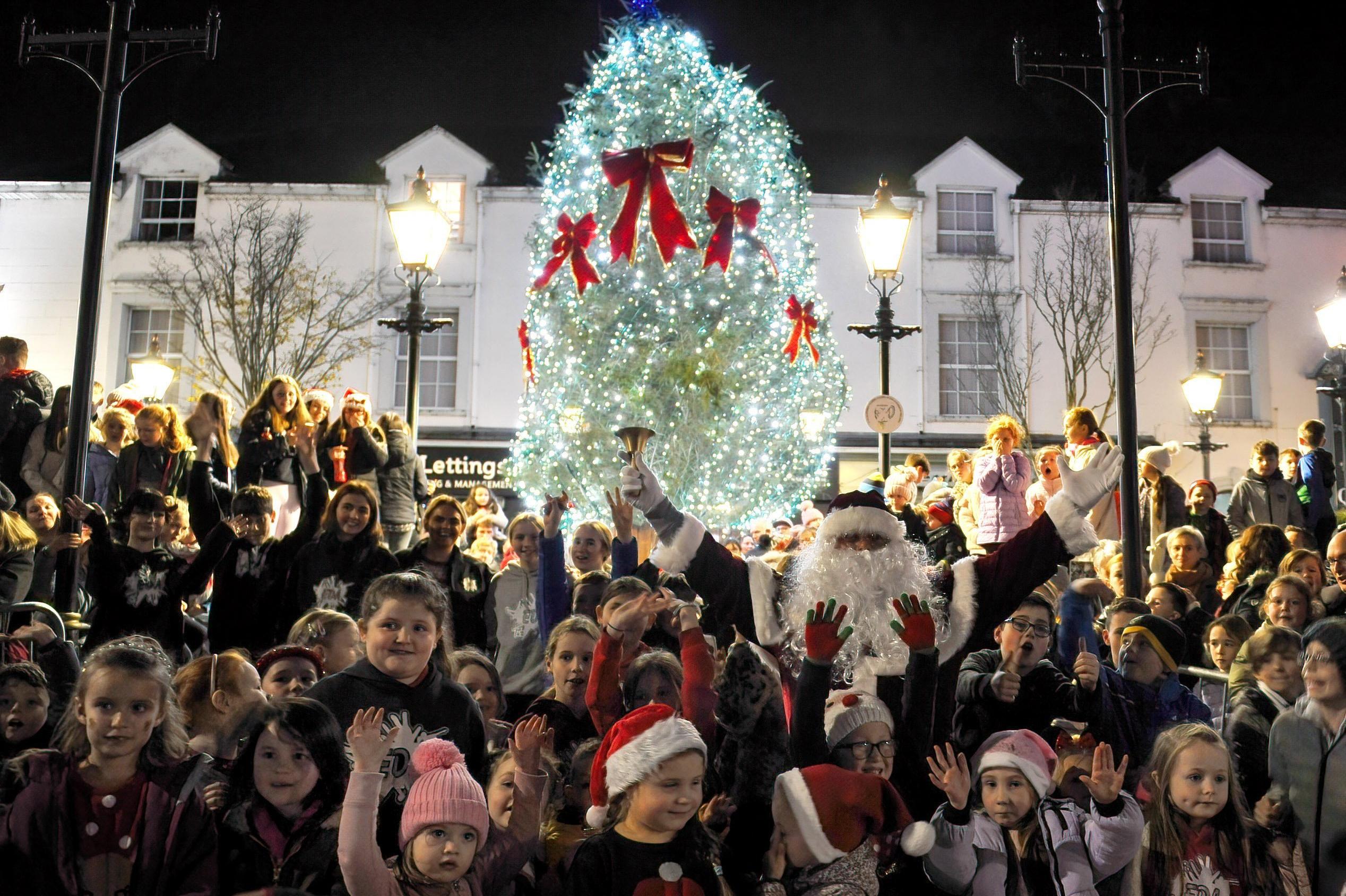 Santa and his helpers pictured at the Buncrana Christmas tree after the lights were switched on Friday evening last. Photo: George Sweeney.  DER2146GS – 029