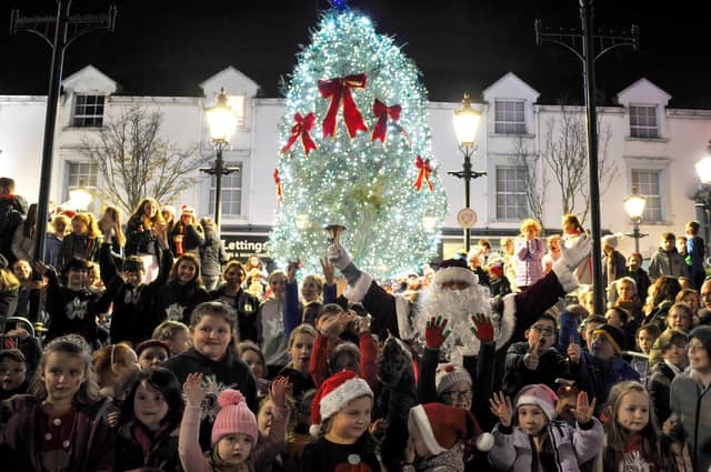 Santa and his helpers pictured at the Buncrana Christmas tree after the lights were switched on Friday evening last. Photo: George Sweeney. DER2146GS – 029