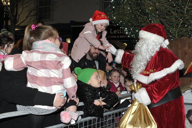 Santa greets children at the switching on of the Christmas tree lights in Buncrana on Friday evening last. Photo: George Sweeney.  DER2146GS – 039