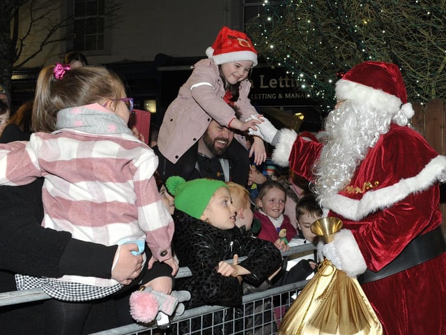 Santa greets children at the switching on of the Christmas tree lights in Buncrana on Friday evening last. Photo: George Sweeney. DER2146GS – 039