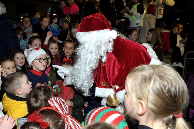 Santa greets children at the switching on of the Christmas tree lights in Buncrana on Friday evening last. Photo: George Sweeney.  DER2146GS – 041
