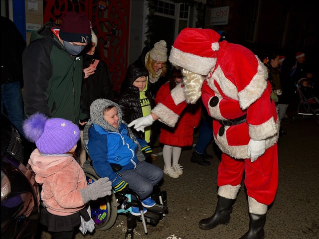 Santa greeting children at the Derry Christmas Lights parade on Sunday evening last. Photo: George Sweeney.  DER2147GS – 018