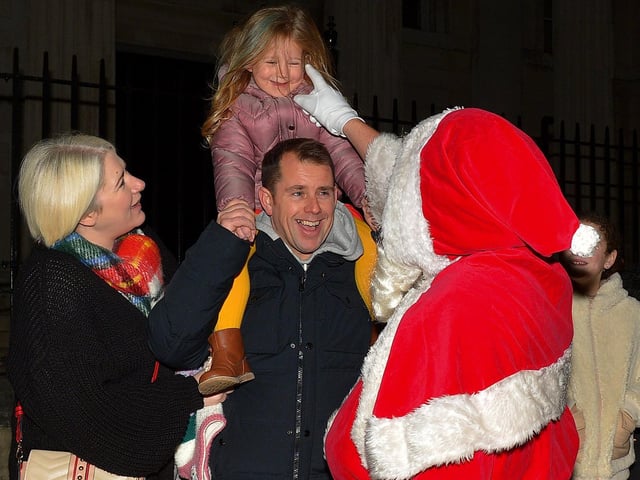 Santa greeting children at the Derry Christmas Lights parade on Sunday evening last. Photo: George Sweeney.  DER2147GS – 014