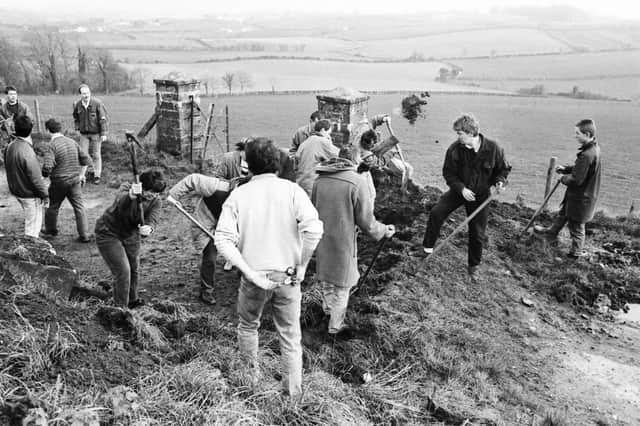 Members of the Derry/Donegal Border Community Association removing the ‘dragons’ teeth’ blocks on the Upper Killea Road outside Derry.