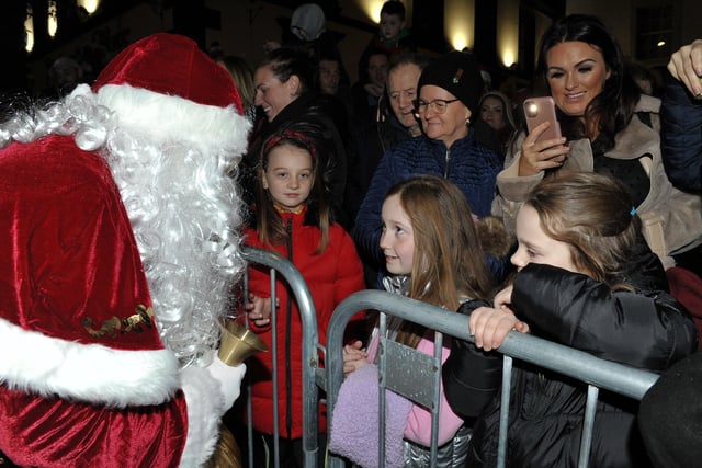 Santa greets children at the switching on of the Christmas tree lights in Buncrana on Friday evening last. Photo: George Sweeney.  DER2146GS – 037
