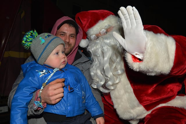 Santa greets children at the switching on of the Christmas tree lights in Moville on Sunday evening last. Photo: George Sweeney.  DER2148GS – 011