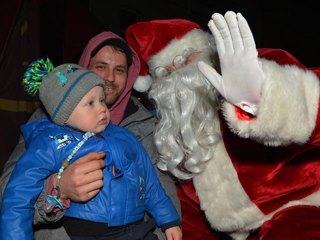 Santa greets children at the switching on of the Christmas tree lights in Moville on Sunday evening last. Photo: George Sweeney.  DER2148GS – 011
