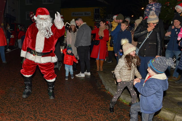 Santa greets children at the switching on of the Christmas tree lights in Moville on Sunday evening last. Photo: George Sweeney.  DER2148GS – 012