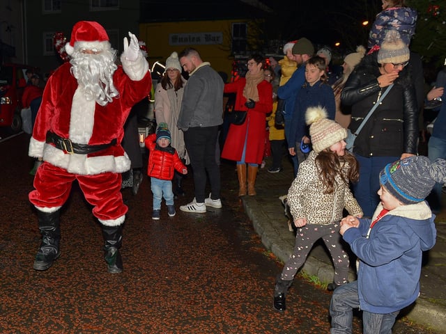 Santa greets children at the switching on of the Christmas tree lights in Moville on Sunday evening last. Photo: George Sweeney.  DER2148GS – 012