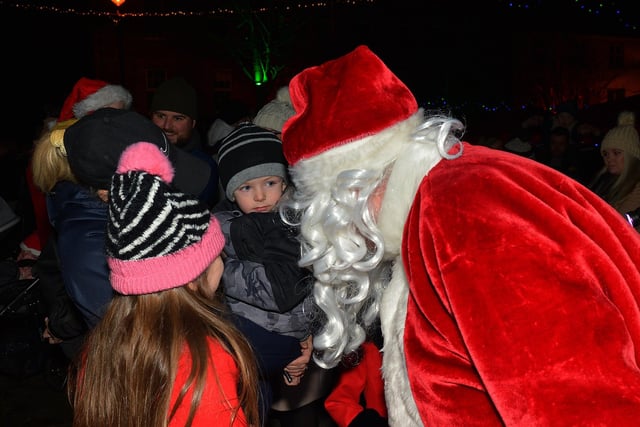 Santa greets children at the switching on of the Christmas tree lights in Moville on Sunday evening last. Photo: George Sweeney.  DER2148GS – 007