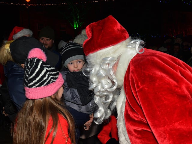 Santa greets children at the switching on of the Christmas tree lights in Moville on Sunday evening last. Photo: George Sweeney. DER2148GS – 007