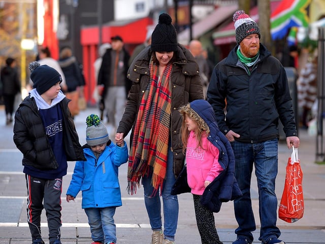 Family visiting the Christmas Market in Guildhall Square on Saturday afternoon last. Photo: George Sweeney. DER2148GS – 051