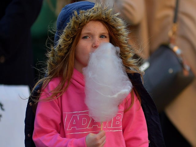 Adam B fan enjoying a candyfloss at the Christmas Market in Guildhall Square on Saturday afternoon last. Photo: George Sweeney.  DER2148GS – 052