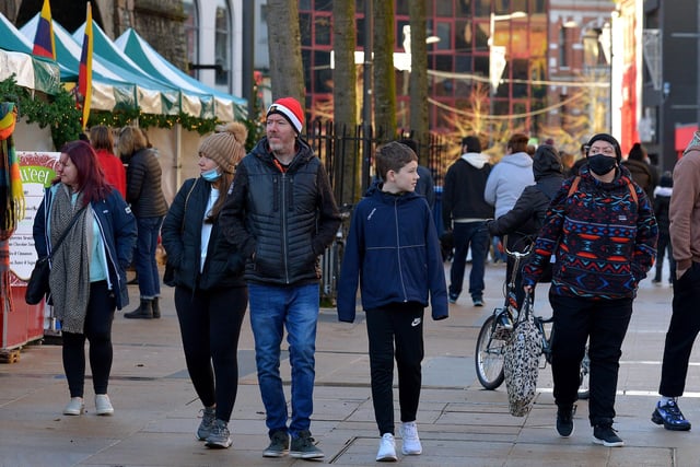 People stroll through the Christmas Market in Guildhall Square on Saturday afternoon last. Photo: George Sweeney.  DER2148GS – 053