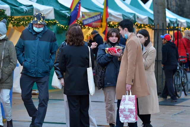 Shoppers enjoy a snack at the Christmas Market in Guildhall Square on Saturday afternoon last. Photo: George Sweeney.  DER2148GS – 058