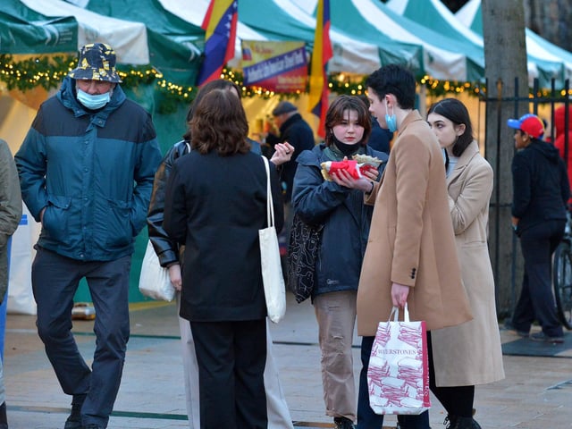 Shoppers enjoy a snack at the Christmas Market in Guildhall Square on Saturday afternoon last. Photo: George Sweeney. DER2148GS – 058