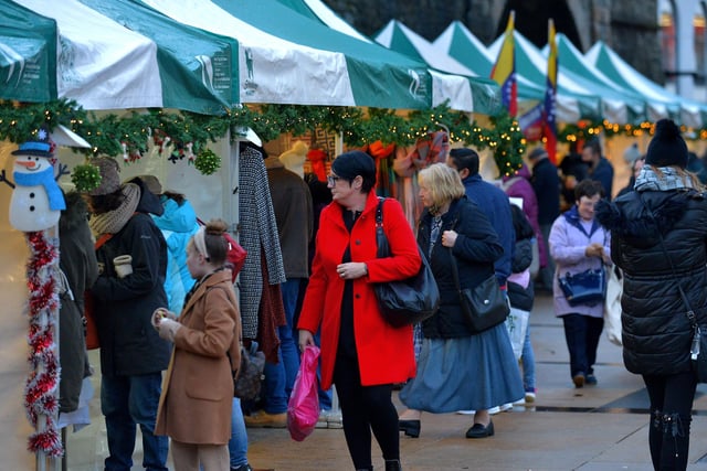 People browse at the Christmas Market in Guildhall Square on Saturday afternoon last. Photo: George Sweeney.  DER2148GS – 056