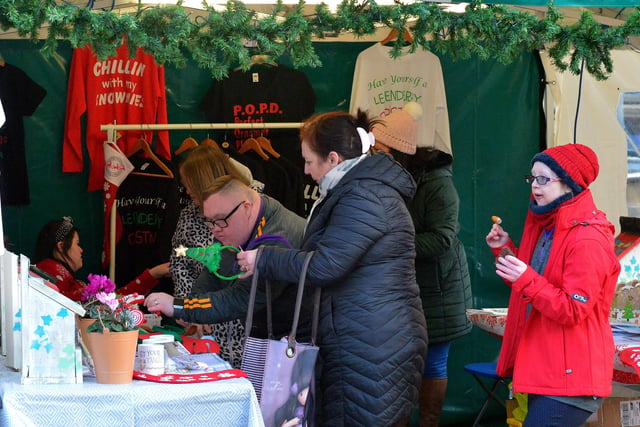 People browse the stalls at the Christmas Market in Guildhall Square on Saturday afternoon last. Photo: George Sweeney.  DER2148GS – 049