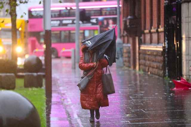 A member of the public battles the wind and rain in Belfast City Centre.