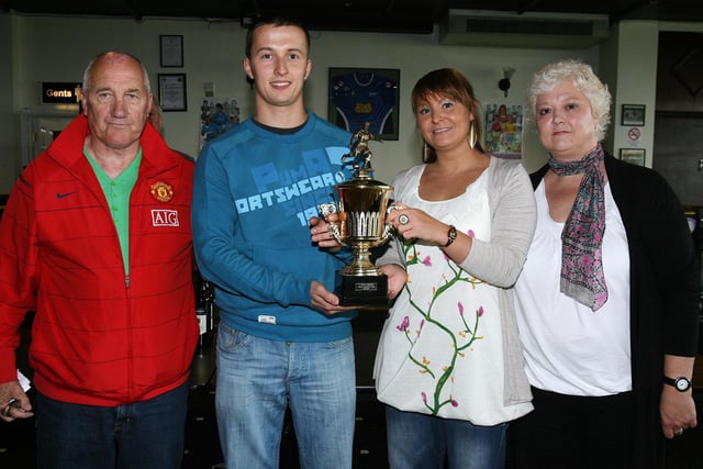 Robert Demski of the White Eagles is presented with the most sporting team award from Claire Acheson at the LMA presentation in the Coleraine FC Social Club on Saturday. Included are Tommy Doherty and Elaine Acheson. CR29-PL