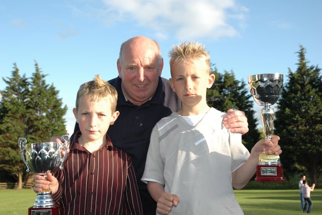 SO PROUD... Jimmy McGonigle with grandsons Kyle and Shane at the Bertie Peacock Youths awards night at Killowen Primary School. Cr22-327(s)