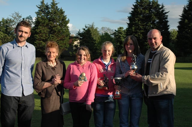 GIRL POWER.. Alan and Ruby Peacock pictured with Amy Gibson ( Most Improved Player), Lauren Wade (Players' Player of the Year) and Zoe Campbell ( Player of the Year) from the Bertie Peacock Youths girls team. Also included in the photograph is Reeves Doherty from West Bann Coleraine Supporters Club. Cr22-321(s)