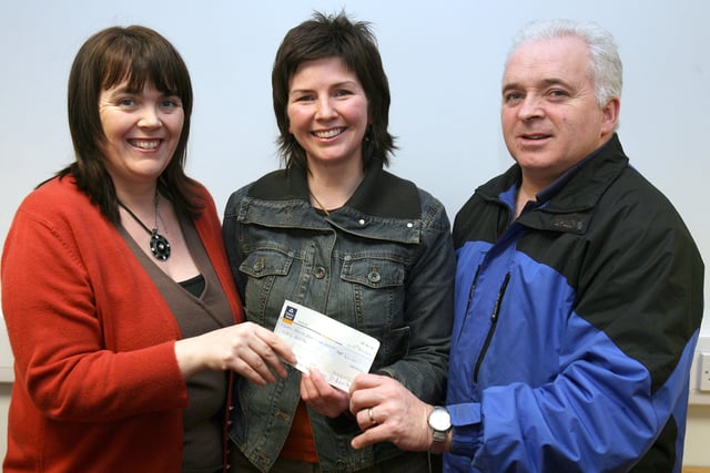 Moira McIvor, treasurer, and Barney Gilmore, committee member, present a cheque to Donna Kilgore of The Bertie Peacock Youth Football Club. The cheque was from funds raised during the Fern Festival 2006. CR3-301PL