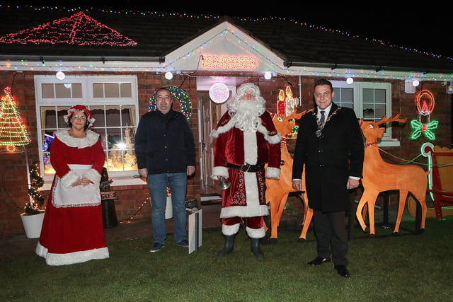 Mayor Graham Warke with Santa and Mrs. Clause when he visited Amelia Court Christmas tree lights. Houses in the area are lit up to raise funding in aid of local girl Nicole, who suffers from FND (Functional Neurological Di?sorder).  Included is Colr. Brian Tierney. (Photo - Tom Heaney, nwpresspics)