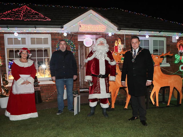 Mayor Graham Warke with Santa and Mrs. Clause when he visited Amelia Court Christmas tree lights. Houses in the area are lit up to raise funding in aid of local girl Nicole, who suffers from FND (Functional Neurological Di?sorder). Included is Colr. Brian Tierney. (Photo - Tom Heaney, nwpresspics)