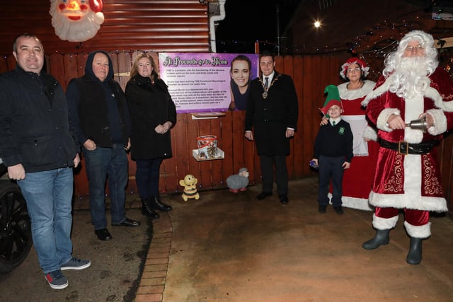 Mayor Graham Warke with Santa, Mrs. Clause and Elf when he visited Amelia Court Christmas tree lights. Houses in the area are lit up to raise funding in aid of local girl Nicole, who suffers from FND (Functional Neurological Disorder). Included from left are Colr. Brian Tierney, Phonsie McDermott and Nicola McDaid, parents of Nicole. (Photo - Tom Heaney, nwpresspics)