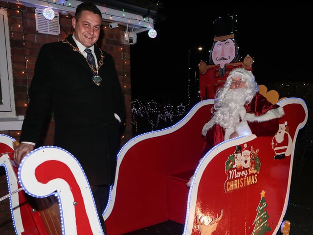 Mayor Graham Warke with Santa on his sleigh when he visited Amelia Court Christmas tree lights. Included is Colr. Brian Tierney. (Photo - Tom Heaney, nwpresspics)
