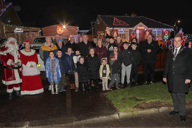 Mayor Graham Warke with Santa, Mrs. Clause and residents when he visited Amelia Court Christmas tree lights. Houses in the area are lit up to raise funding in aid of local girl Nicole, who suffers from FND (Functional Neurological Disorder). (Photo - Tom Heaney, nwpresspics)