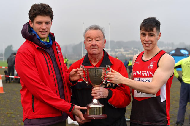 Fintan Stewart and Luke McCarron , representing City of Derry Spartans men’s team, receive the Bobby Farren Snr Memorial Cup, from Charlie Large, at the North West Cross Country meeting. Photo: George Sweeney.  DER2150GS – 057