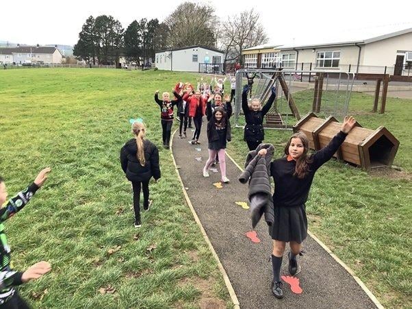 Primary six children raced around the daily mile track in a record time.