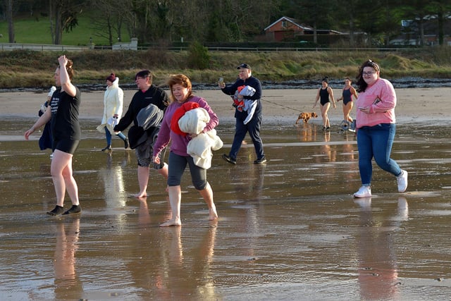 People make their way into the sea for the ARC Fitness New Year’s Day Charity Swim at Lisfannon beach, Inishowen. Photo: George Sweeney.  DER2152GS – 009