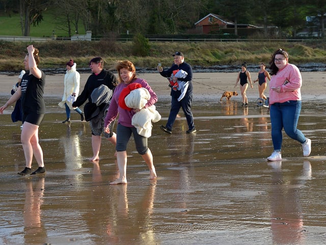 People make their way into the sea for the ARC Fitness New Year’s Day Charity Swim at Lisfannon beach, Inishowen. Photo: George Sweeney. DER2152GS – 009