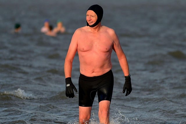 Keeping warm during the ARC Fitness New Year’s Day Charity Swim at Lisfannon beach, Inishowen. Photo: George Sweeney.  DER2152GS – 020
