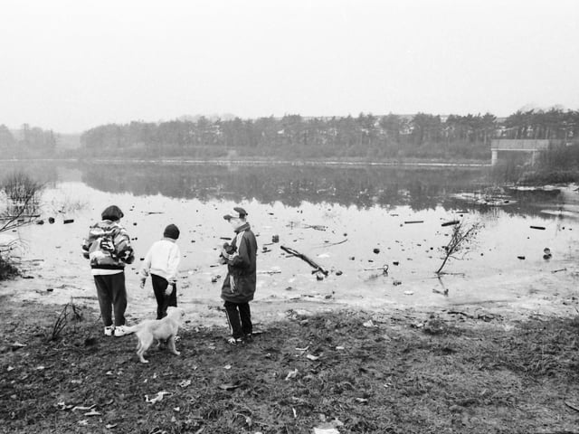 Children playing on the banks of an icy Glenowen reservoir.