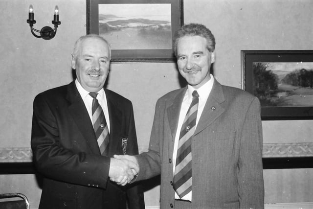Colm O’Kane, outgoing captain at Ballyliffin Golf Club, congratulates the new captain, Hugo Boyce, at the club’s annual dinner which was held in the Strand Hotel.